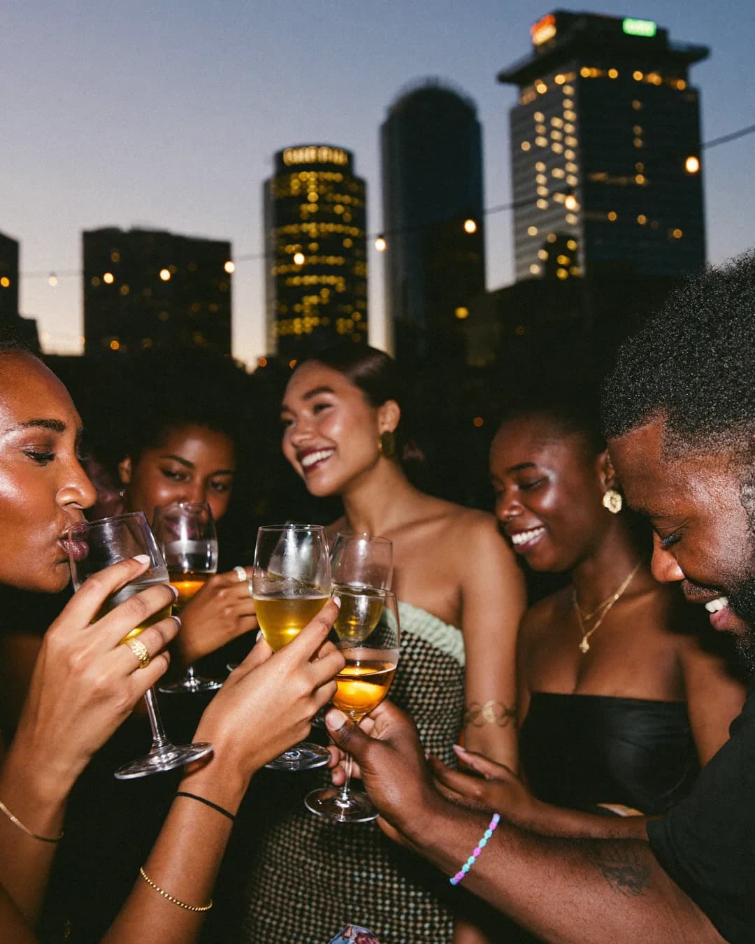 Rooftop watch party at blue hour
